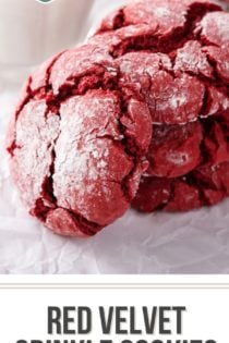 Three stacked red velvet crinkle cookies with a fourth cookie leaning against the stack. Text overlay includes recipe name.