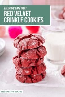 Five red velvet crinkle cookies stacked on a piece of parchment in front of a glass of milk. Text overlay includes recipe name.