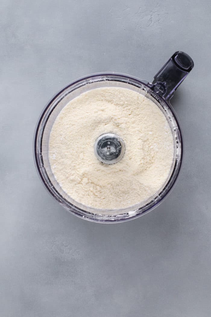 Pulsed base for shortbread crust in the bowl of a food processor.