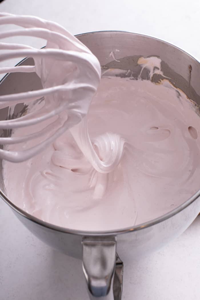 Freshly mixed strawberry marshmallow mixture in a metal mixing bowl.