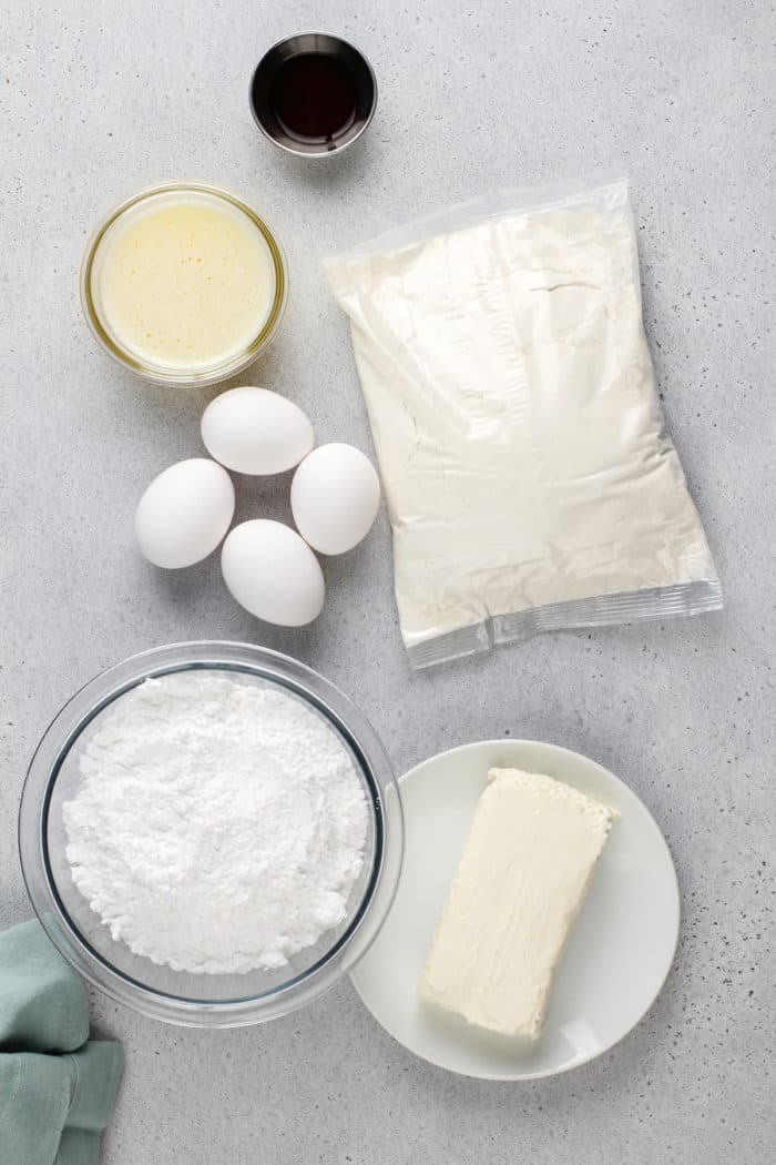 Easy gooey butter cake ingredients arranged on a gray countertop.