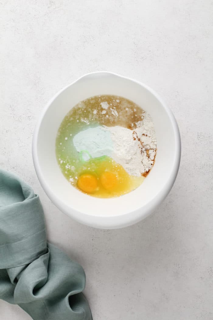 Ingredients for st. patrick's day crinkle cookies in a white mixing bowl.