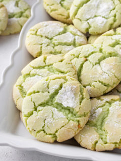 St. Patricks Day crinkle cookies on a white platter.