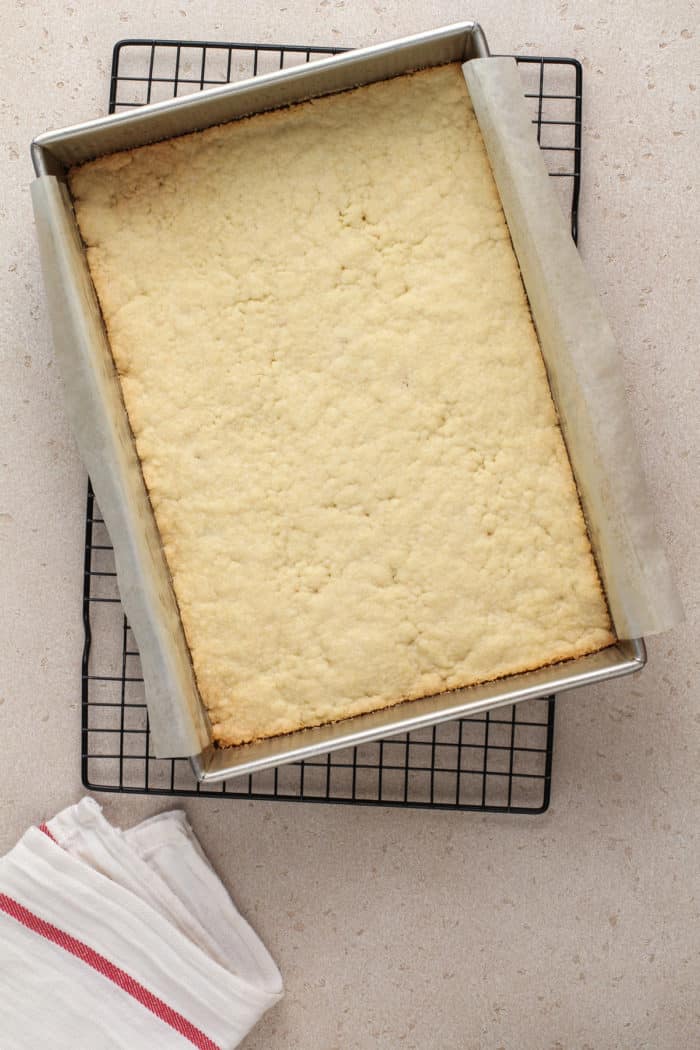 Baked crust for nana's easy cheesecake cooling on a wire rack.