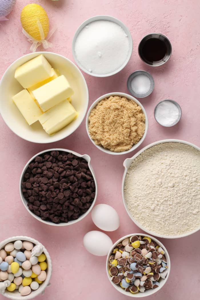 Cadbury egg cookie ingredients arranged on a pink countertop.