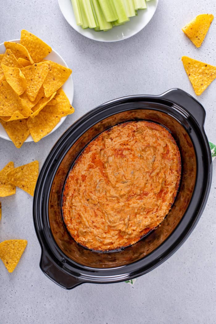 Overhead view of cooked slow cooker buffalo chicken dip in the crock of a slow cooker.