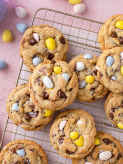 Cadbury egg cookies scattered on a wire cooling rack.