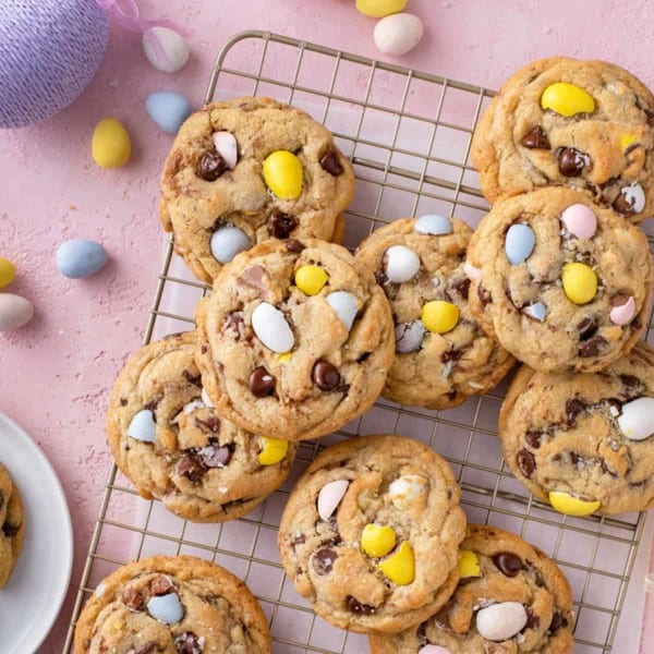 Cadbury egg cookies scattered on a wire cooling rack.