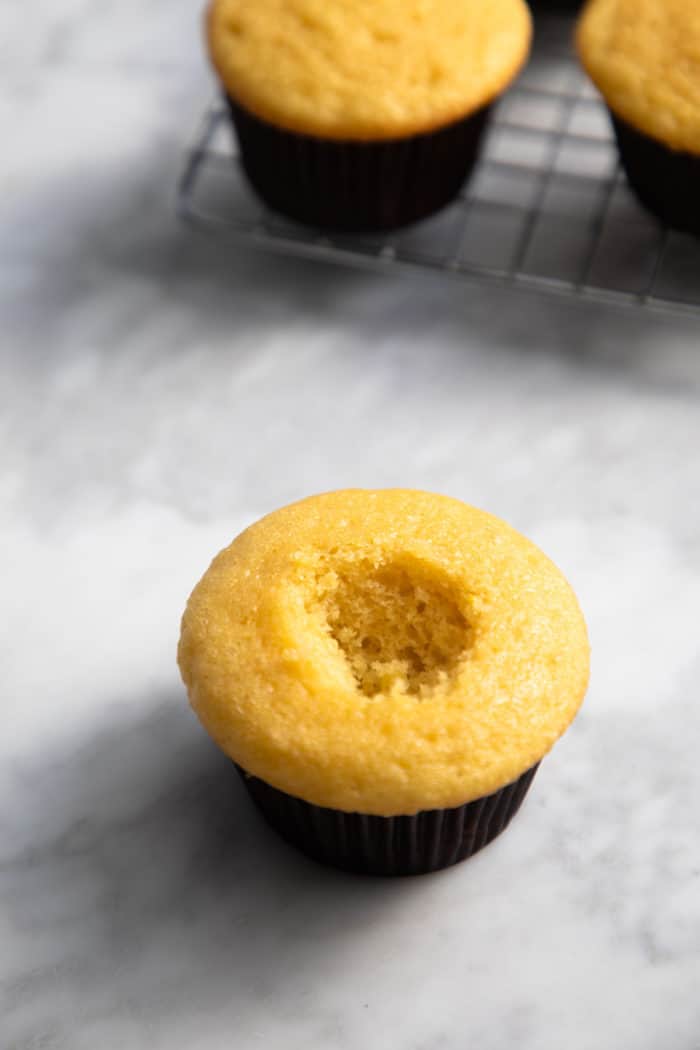 Cupcake that has had the center hollowed out with a paring knife.