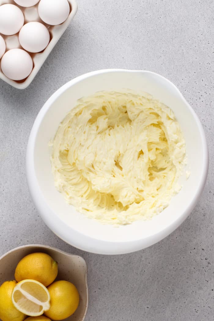 Butter and cream cheese creamed together in a white bowl.