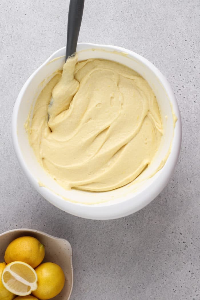Lemon cream cheese pound cake batter in a white mixing bowl.