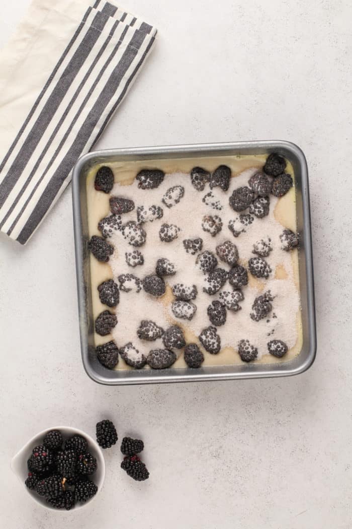 Easy blackberry cobbler assembled in the pan and ready go to in the oven.