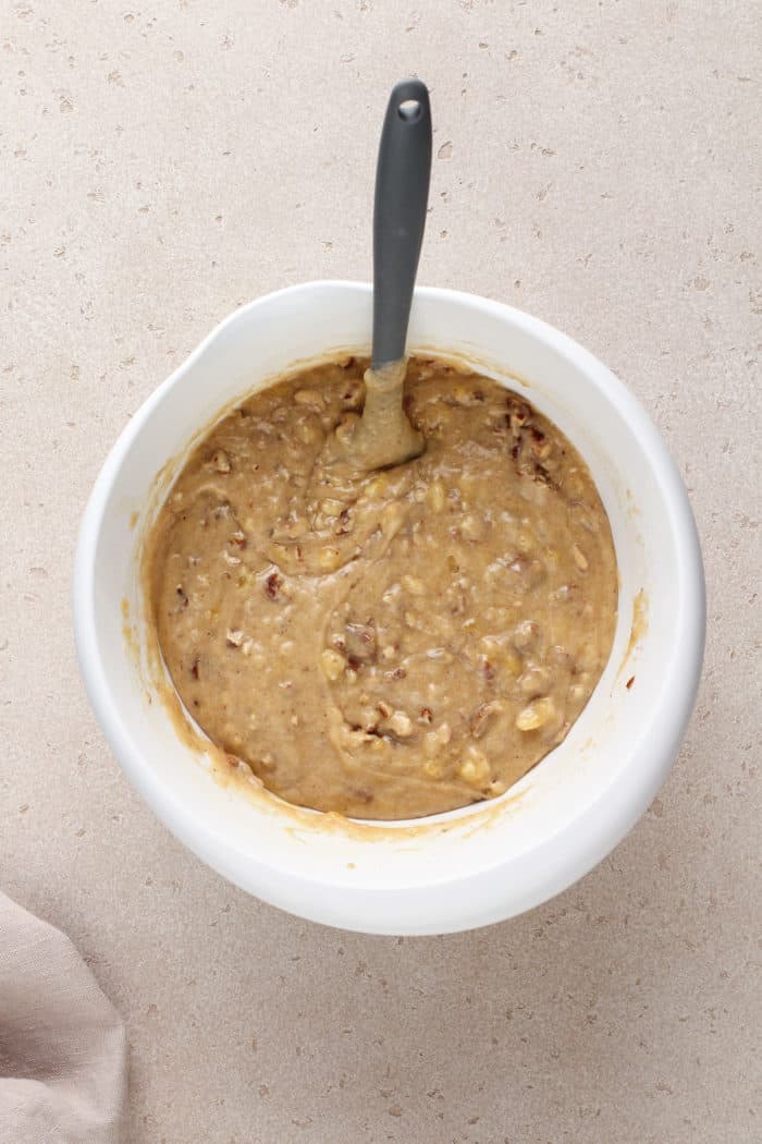 Banana nut bread batter in a white mixing bowl.