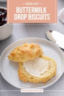 Buttermilk drop biscuit cut in half and spread with butter on a white plate. Text overlay includes recipe name.