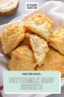 Basket of buttermilk drop biscuits with one of the biscuits broken in half to show the crumb texture. Text overlay includes recipe name.