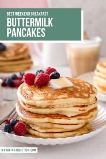 Several buttermilk pancakes stacked on a white plate and garnished with fresh berries. Text overlay includes recipe name.