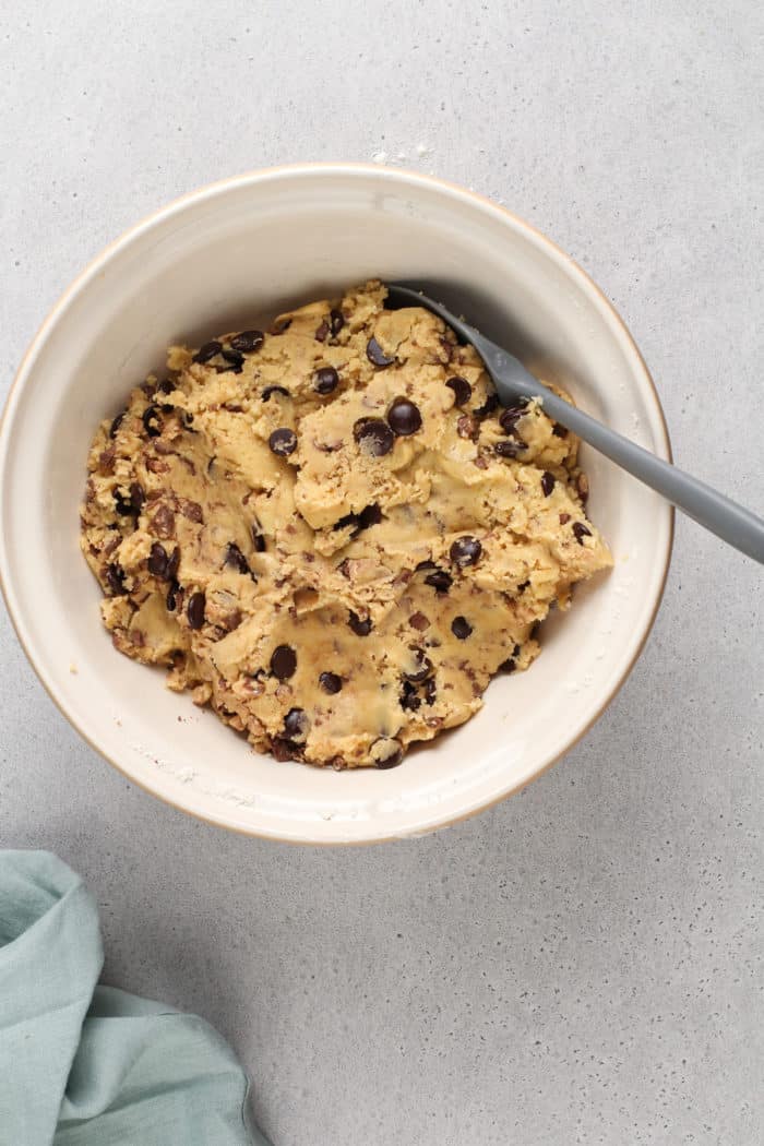 Dough for chocolate chip cookies with brown butter and toffee in a large mixing bowl.