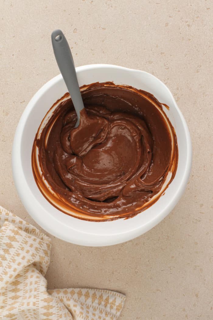 Chocolate pudding layer for peanut butter pretzel dessert in a white mixing bowl.