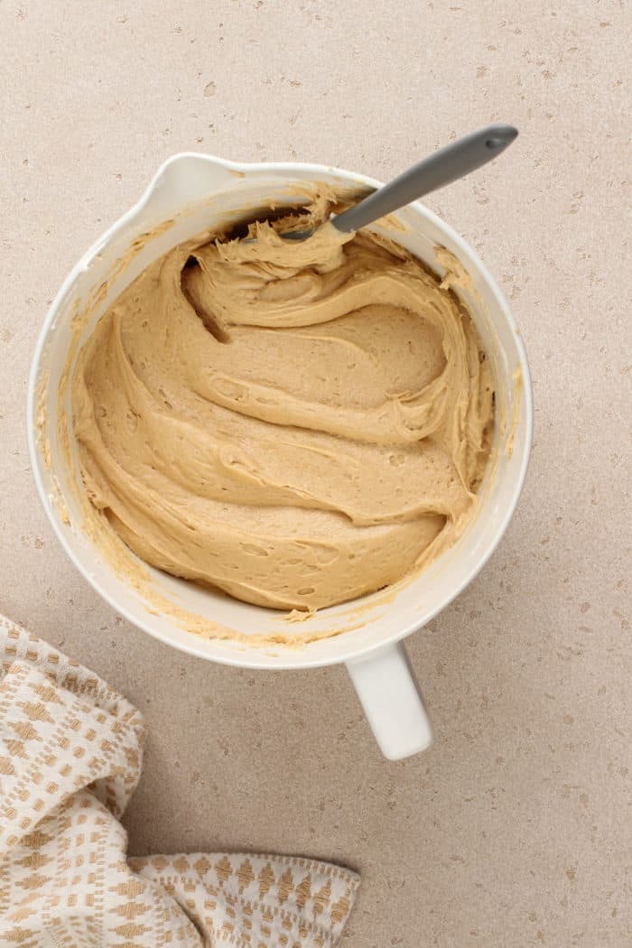 Peanut butter and cream cheese filling folded together in a white mixing bowl.