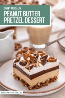 Side of of a slice of peanut butter pretzel dessert on a speckled plate, showing the layers of the piece of dessert. Text overlay includes recipe name.