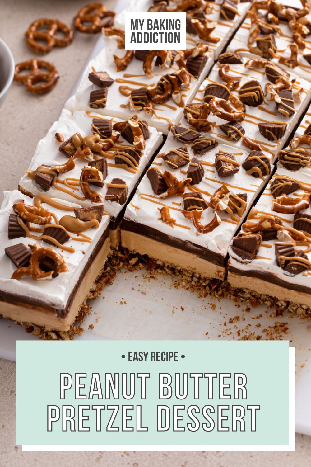 Peanut butter pretzel dessert with two slices removed. Text overlay includes recipe name.