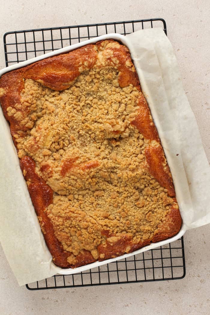 Freshly baked easy peach coffee cake set on a wire rack to cool.