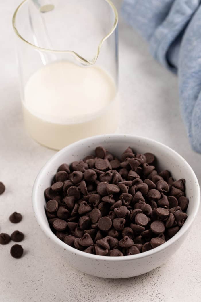 Ingredients for chocolate ganache set on a light-colored countertop.