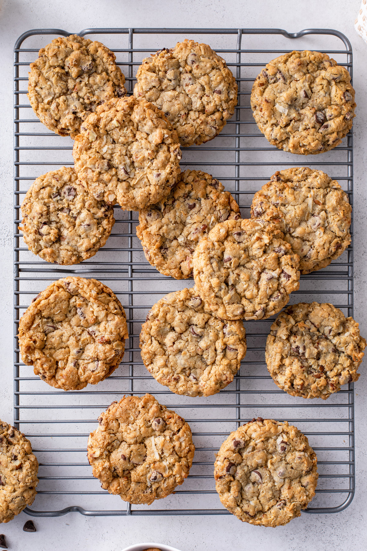 Overhead view of cowboy cookies on a wire cooling rack.