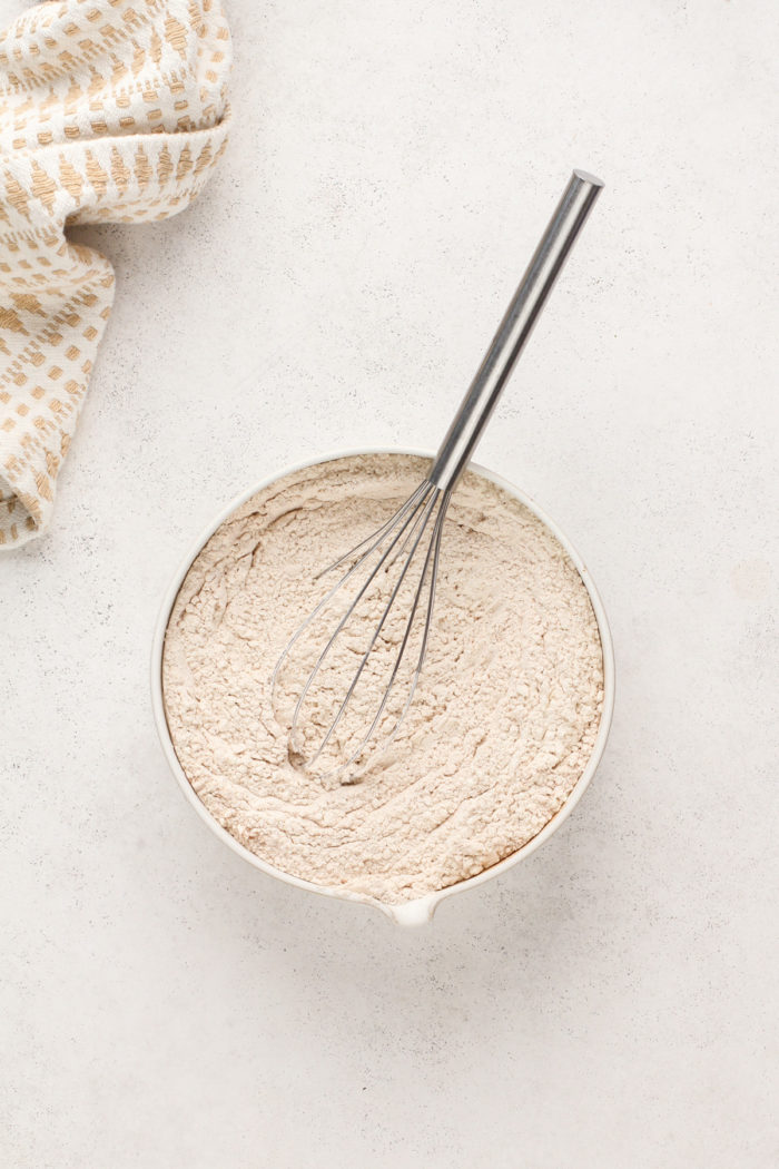 Dry ingredients for cowboy cookies whisked together in a small bowl.