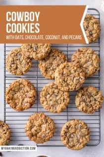 Overhead view of cowboy cookies on a wire cooling rack. Text overlay includes recipe name.