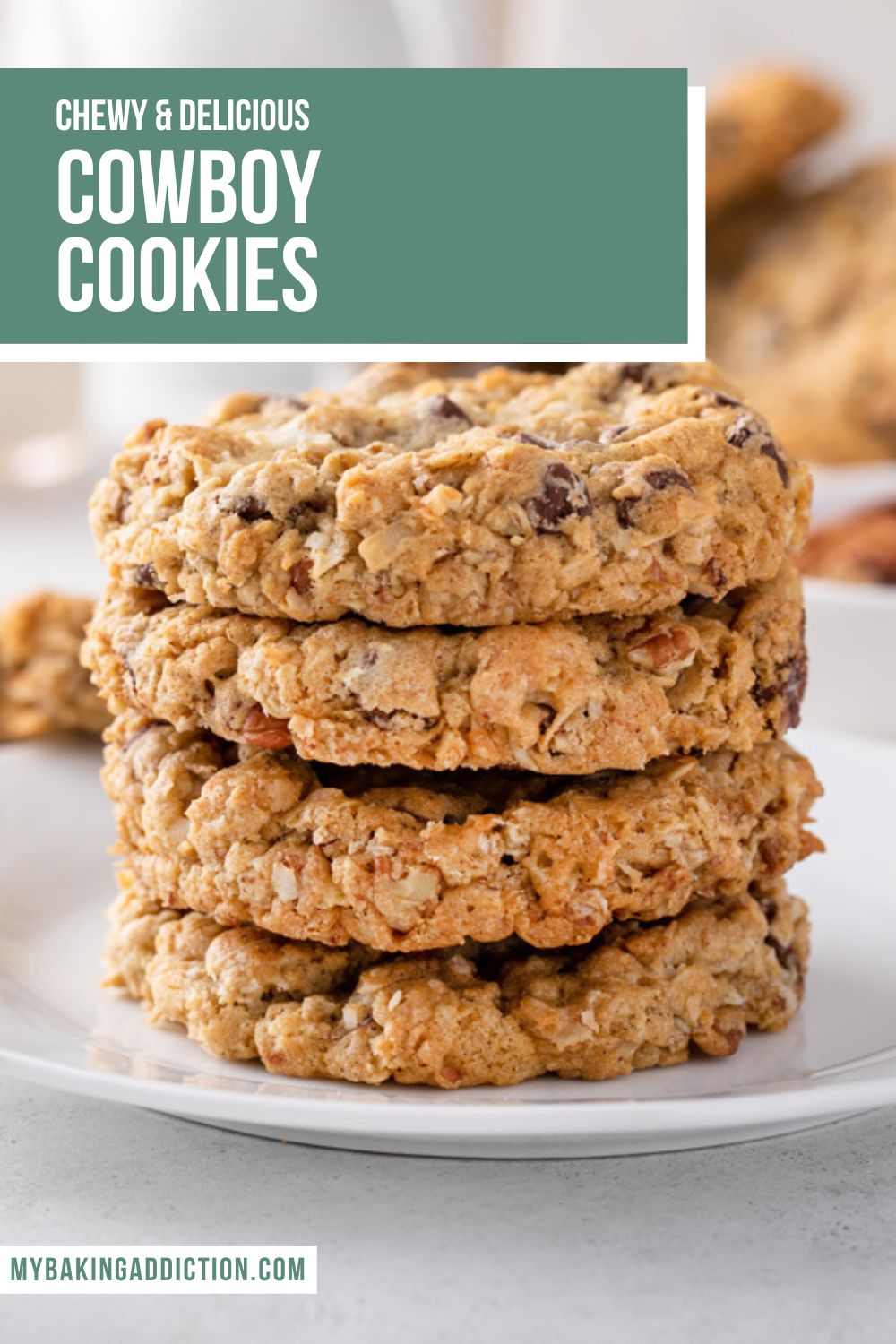 White plate holding a stack of 4 cowboy cookies. Additional cookies and a bowl of chocolate chips are visible in the background. Text overlay includes recipe name.