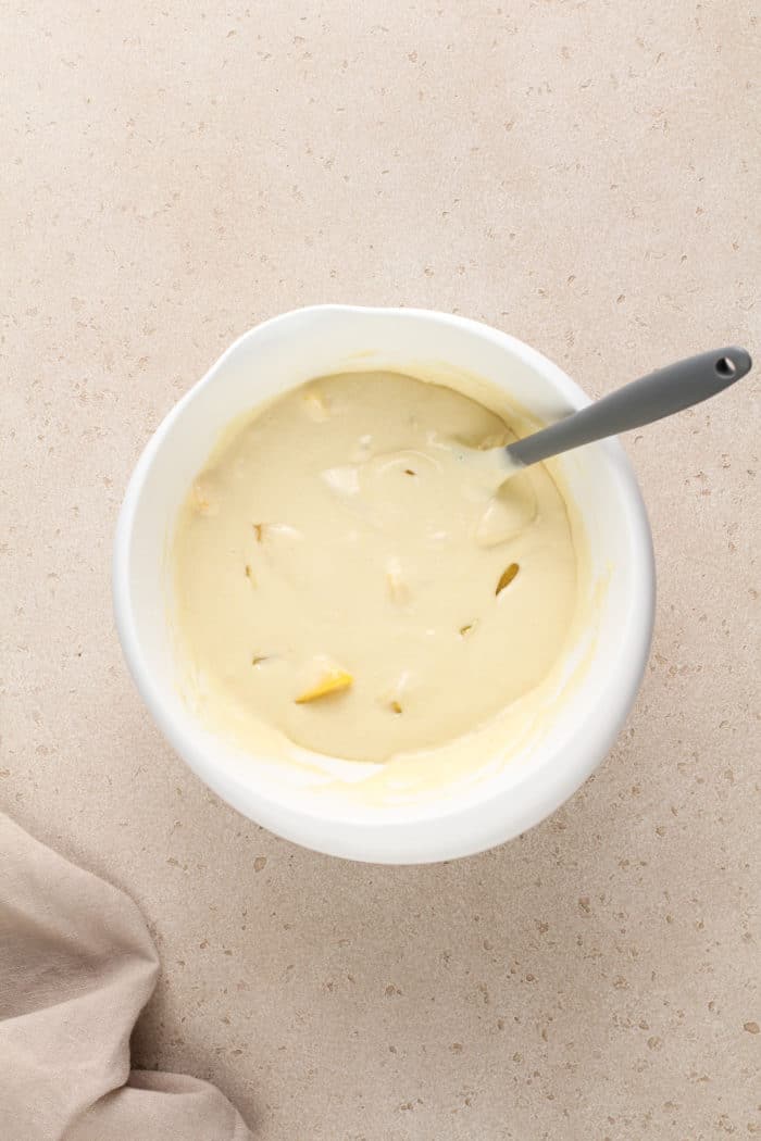 Easy peach coffee cake batter in a white mixing bowl.