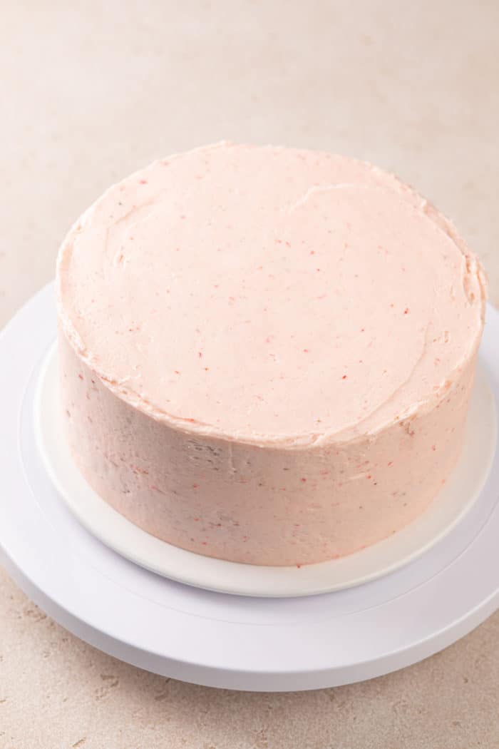 Chocolate cake covered in strawberry frosting.