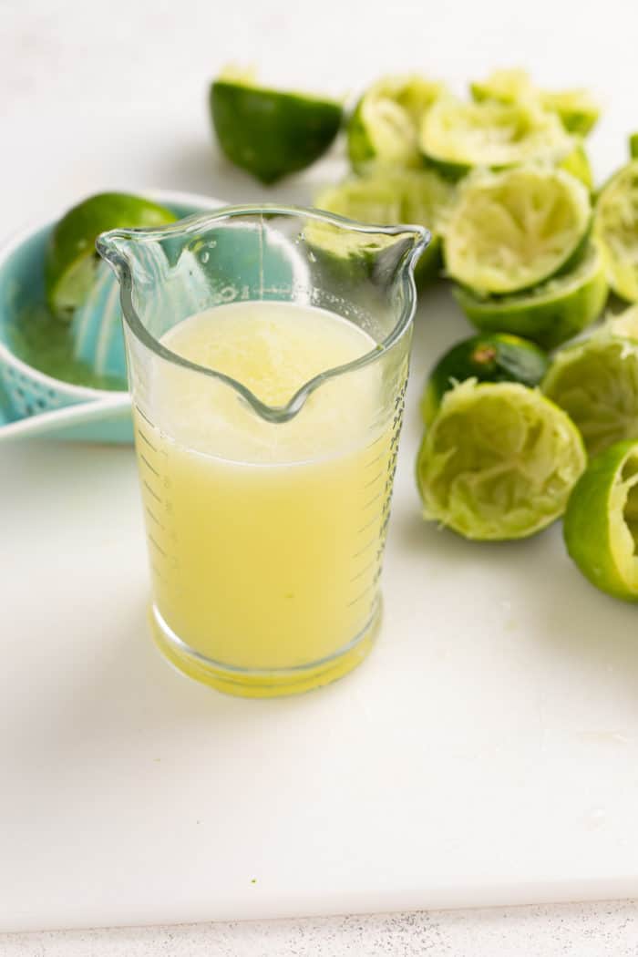 Freshly squeezed lime juice in a glass measuring cup.