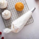 Piping bag filled with whipped cream frosting.