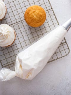 Piping bag filled with whipped cream frosting.