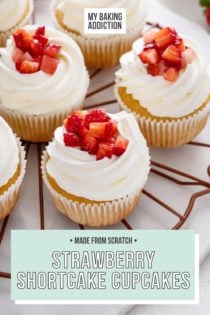 Several strawberry shortcake cupcakes arranged on a round wire rack. Text overlay includes recipe name.