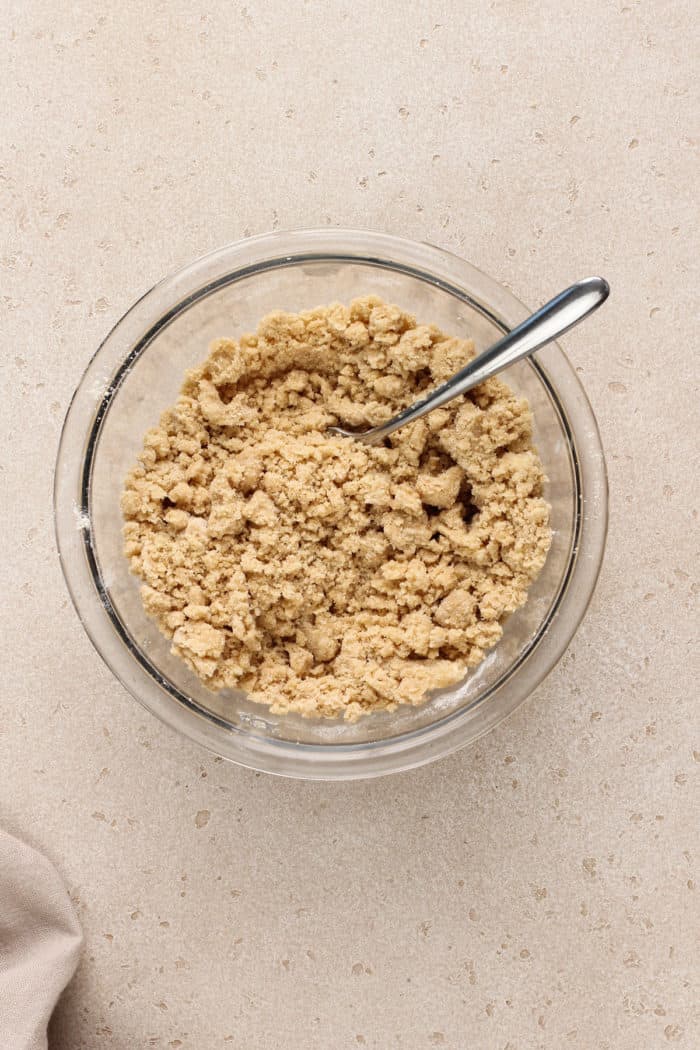 Streusel for easy peach coffee cake in a glass mixing bowl.