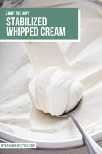 Spoonful of whipped cream frosting set on top of a bowl of the frosting. Text overlay includes recipe name.