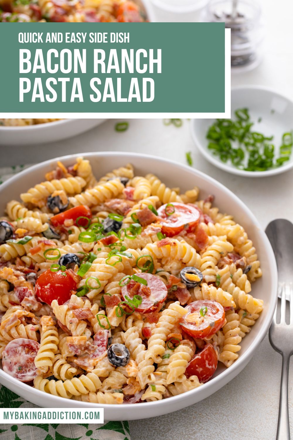 White bowl filled with bacon ranch pasta salad on a white countertop, with a second bowl visible in the background. Text overlay includes recipe name.