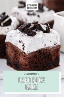 Close up image of a slice of oreo poke cake on a white plate. Two more slices and a glass of milk are visible in the background. text overlay includes recipe name.