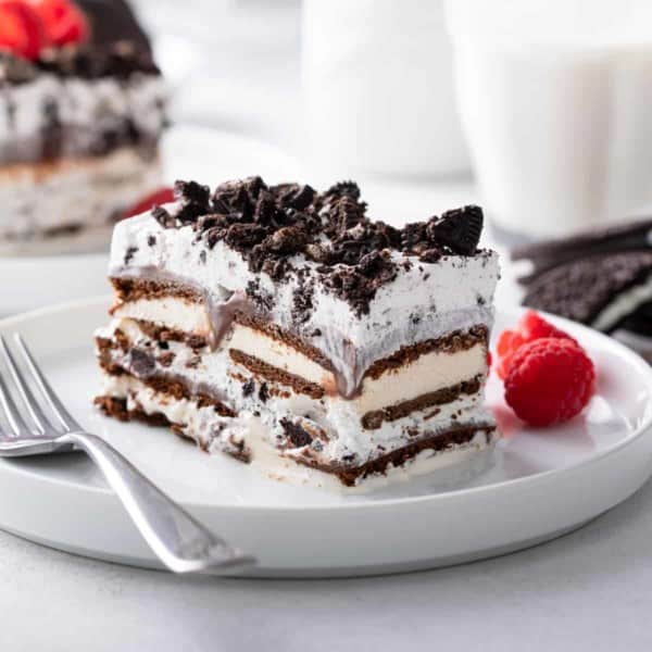 Slice of ice cream sandwich cake on a white plate.