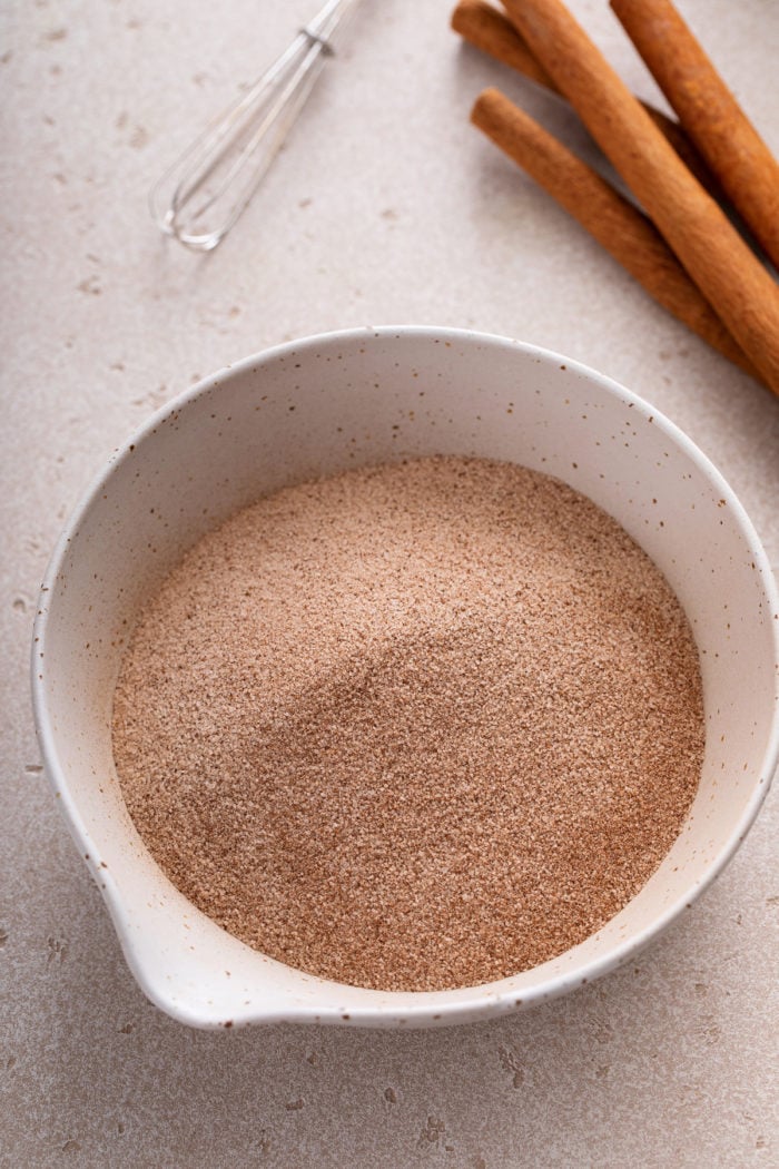 Cinnamon sugar in a small white bowl.