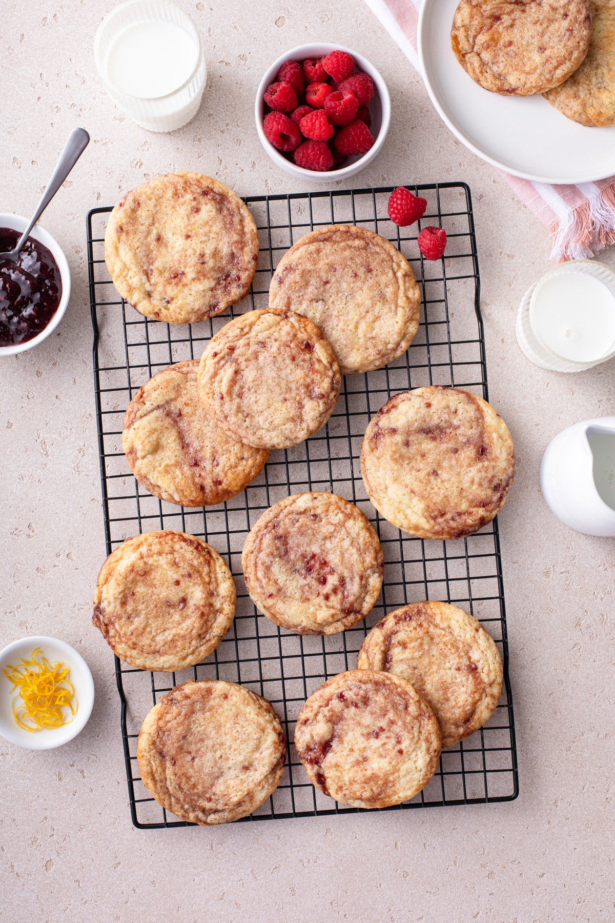 Overhead view of raspberry lemon cookies on a wire cooling rack.