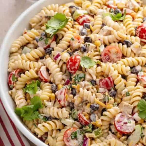 White serving bowl filled with southwest pasta salad.