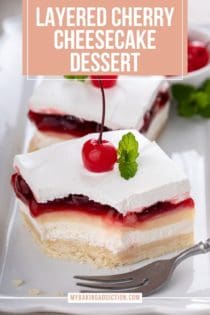 Slice of cherry cheesecake dessert on a white platter with a bite taken from it. A second slice is visible in the background. Text overlay includes recipe name.