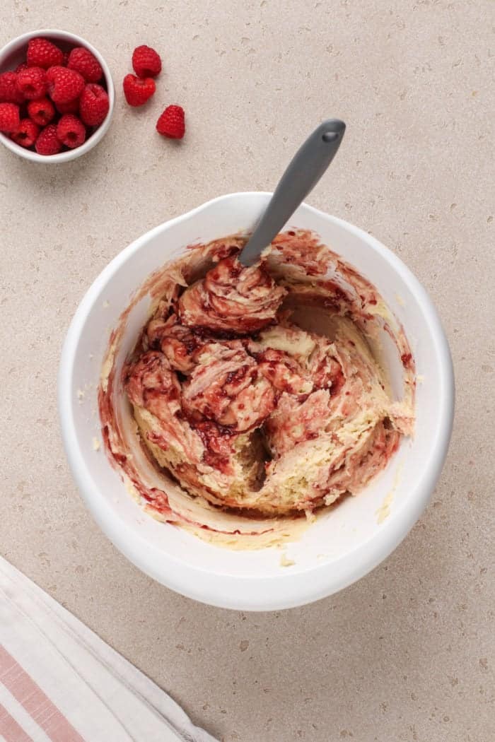 Raspberry lemon cookie dough in a white mixing bowl.