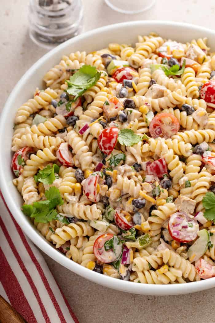 White serving bowl filled with southwest pasta salad.