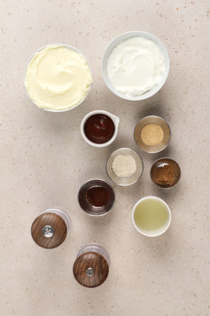 Ingredients for southwest pasta salad dressing arranged on a beige countertop.