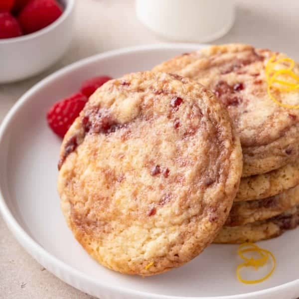 Stack of raspberry lemon cookies on a white plate.